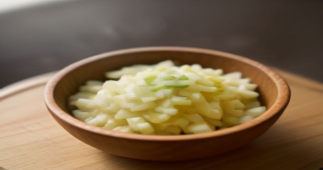 Homemade daikon radish and apple kimchi in a glass fermentation jar with warm kitchen lighting